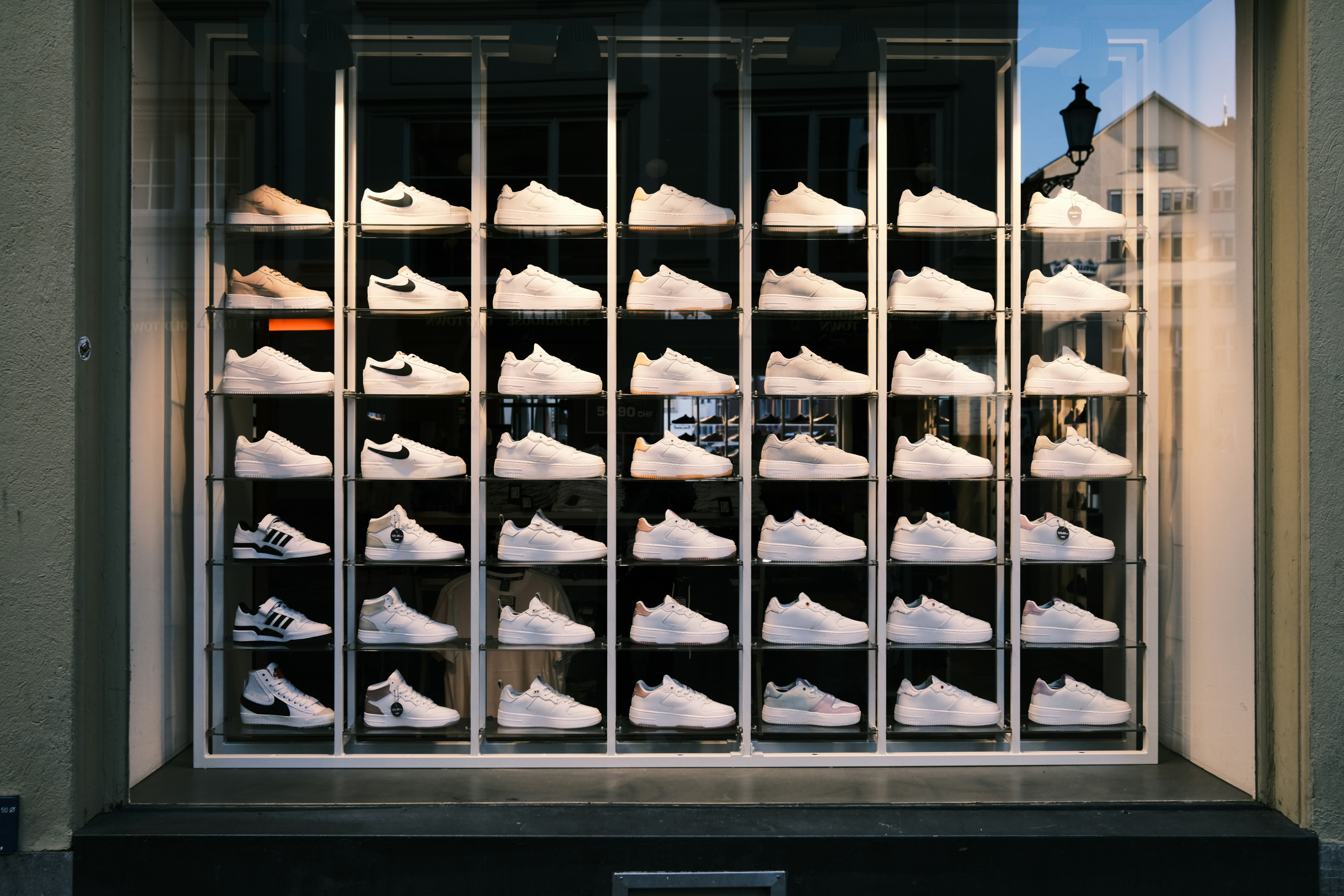a display of white shoes in a window